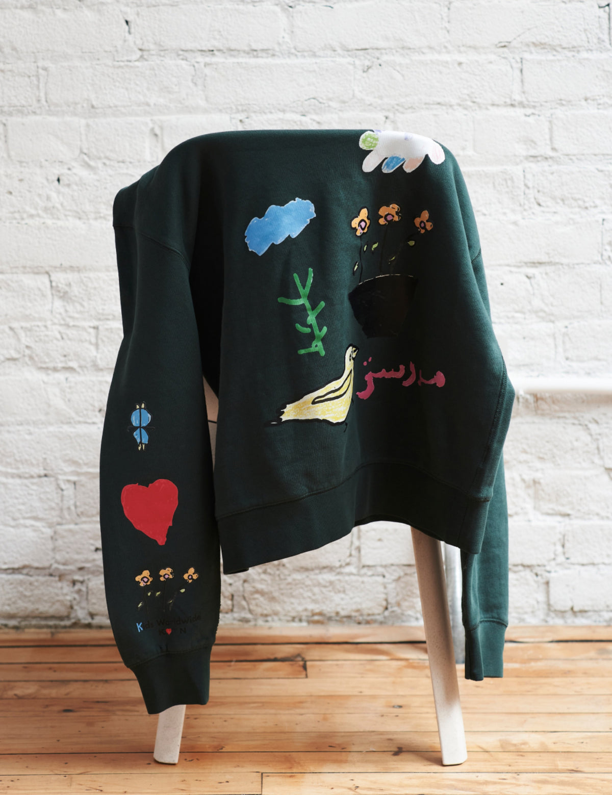 Maya wears the Kotn x KWW Love Collage Essential Sweatshirt