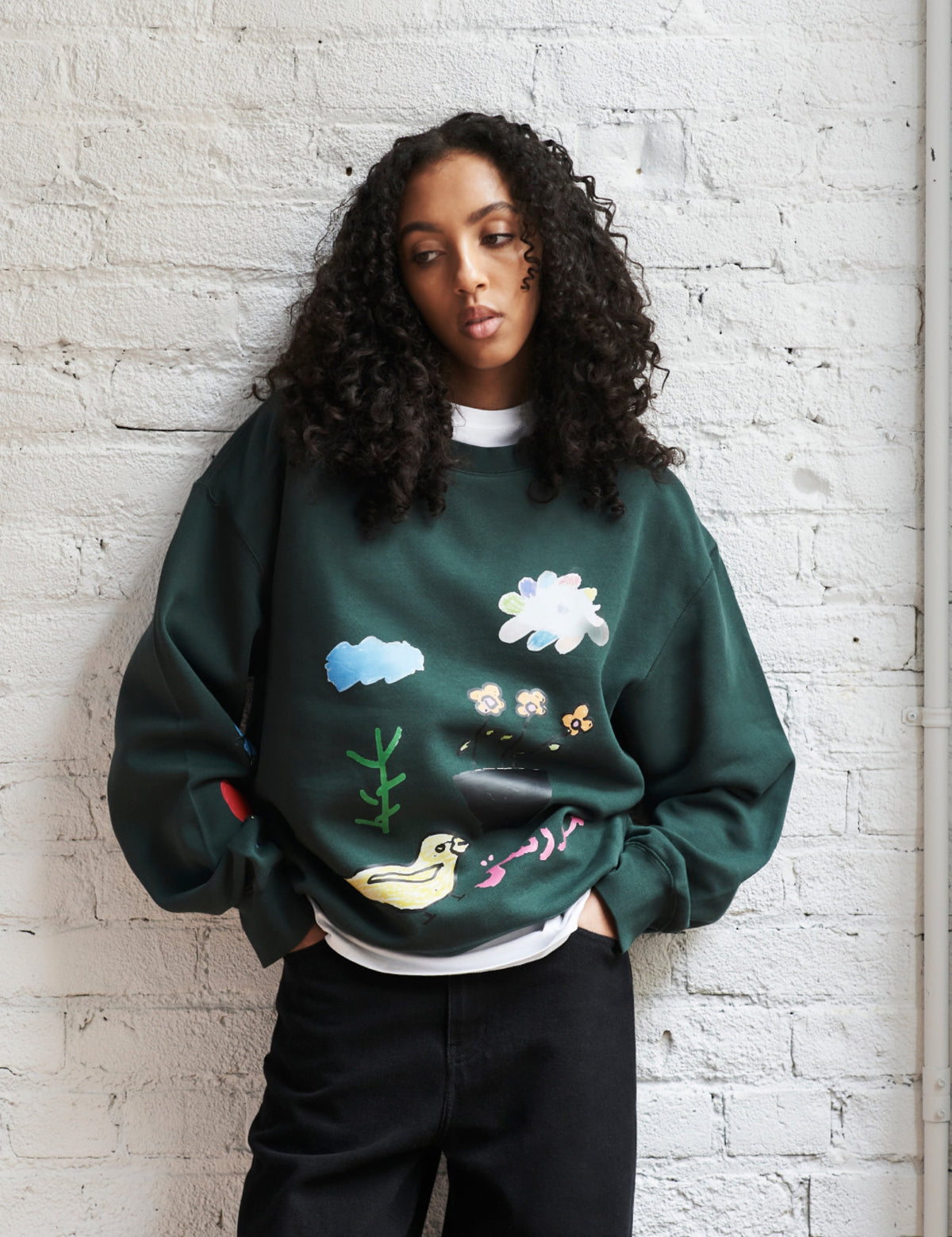 Maya wears the Kotn x KWW Love Collage Essential Sweatshirt